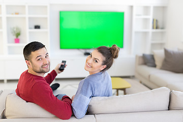 Image showing Young couple on the sofa watching television