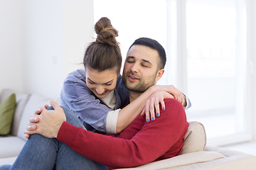 Image showing couple hugging and relaxing on sofa