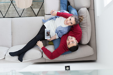 Image showing couple relaxing at  home with tablet computers