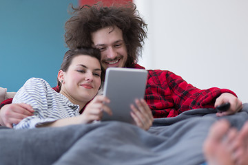 Image showing couple relaxing at  home with tablet computers