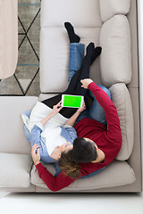 Image showing couple relaxing at  home with tablet computers