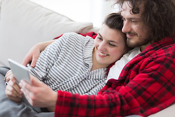 Image showing couple relaxing at  home with tablet computers