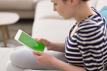 Image showing woman on sofa using tablet computer