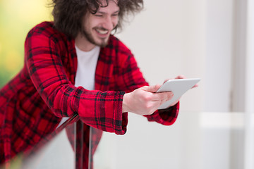 Image showing young freelancer using tablet computer