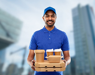 Image showing happy indian delivery man with food and drinks