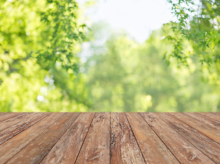 Image showing wooden table with blurred summer park background