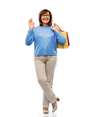 Image showing senior woman with shopping bags isolated on white