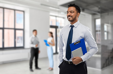 Image showing indian businessman or realtor in empty office room