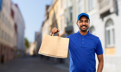 Image showing indian delivery man with food in paper bag in city