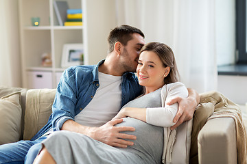 Image showing man hugging pregnant woman at home