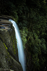 Image showing Cascading waters flow off tall cliffs 