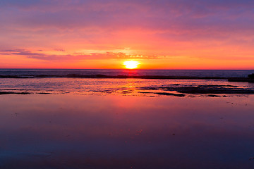 Image showing Coastal sunrises as daybreaks turning skies red, orange, pink and yellow