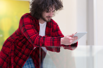 Image showing young freelancer using tablet computer