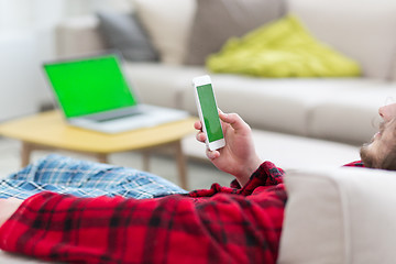 Image showing young man in bathrobe enjoying free time