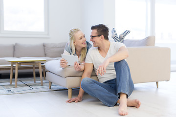 Image showing couple relaxing at  home with tablet computers