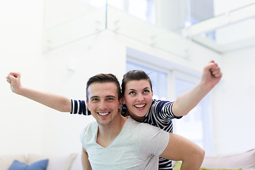 Image showing handsome man piggybacking his girlfriend