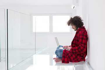 Image showing young freelancer in bathrobe working from home