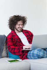 Image showing man freelancer in bathrobe working from home