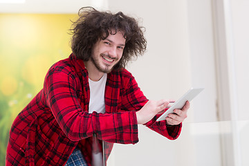 Image showing young freelancer using tablet computer