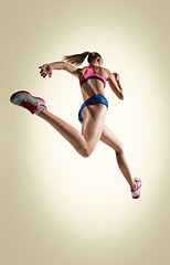 Image showing The studio shot of high jump female athlete is in action