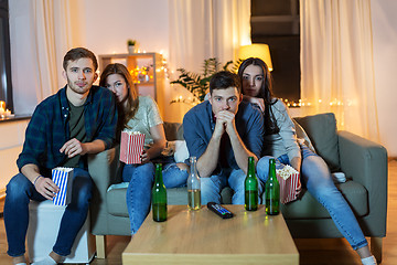 Image showing friends with beer and popcorn watching tv at home