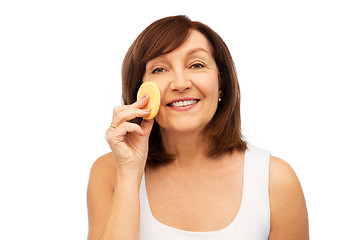 Image showing woman cleaning face with exfoliating sponge