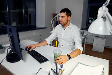 Image showing businessman with computer working at night office