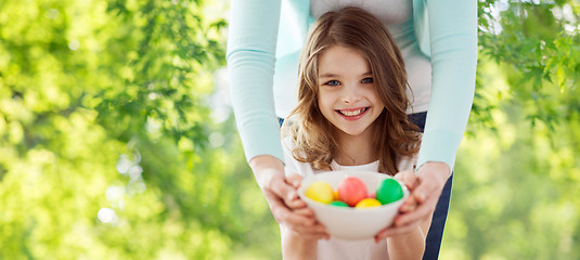 Image showing happy smiling girl and mother with easter eggs