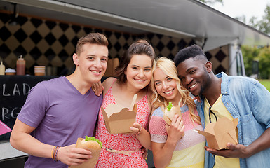 Image showing happy friends with wok and burger at food truck