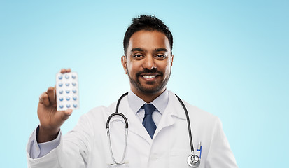 Image showing indian male doctor with pills and stethoscope