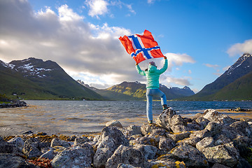 Image showing Woman with a waving flag of Norway on the background of nature