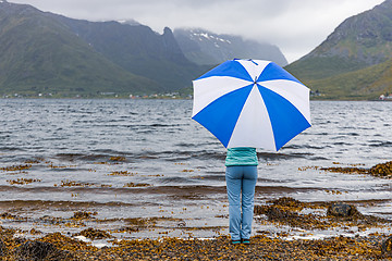 Image showing Woman under an umbrella in the background of nature Norway