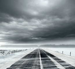 Image showing Stormy sky and snow road