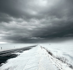 Image showing Stormy sky and snow road