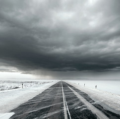 Image showing Stormy sky and snow road