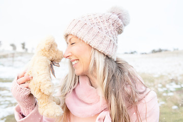 Image showing Smiling woman nose to nose with teddy bear