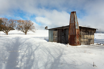 Image showing Rustic log shed or stable in rural countryside with full coverag