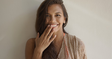 Image showing Laughing woman covering her mouth with hand