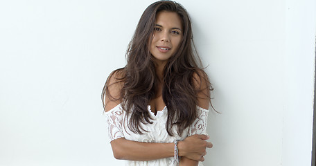 Image showing Sensual brunette in white dress looking at camera