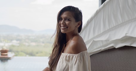 Image showing Adult contented woman on terrace at resort