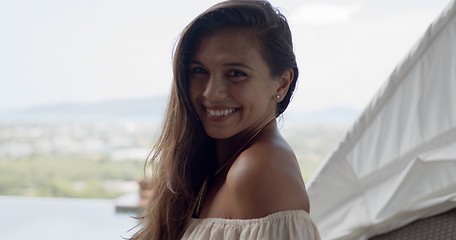 Image showing Happy tourist on terrace at resort in sunny day