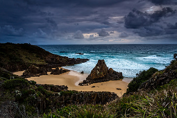 Image showing Stormy skies over coastal landscape with impressive sea stacks