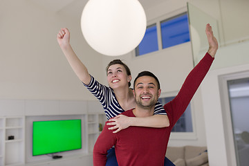 Image showing handsome man piggybacking his girlfriend