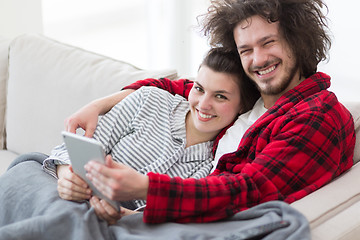 Image showing couple relaxing at  home with tablet computers