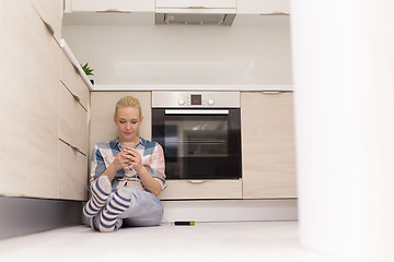 Image showing young women using mobile phone at home