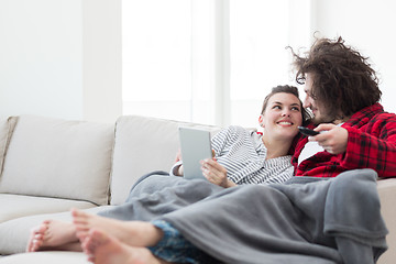 Image showing couple relaxing at  home with tablet computers