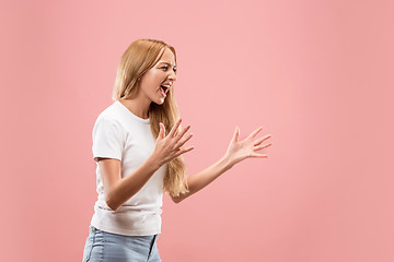 Image showing The young emotional angry woman screaming on studio background