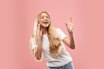 Image showing Isolated on pink young casual woman shouting at studio