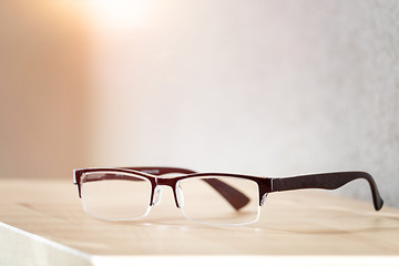 Image showing reading glasses on a wooden table