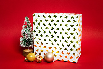 Image showing Christmas decoration gift box with red background